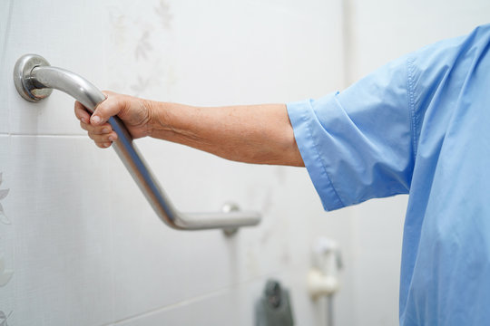 Asian senior or elderly old lady woman patient use toilet bathroom handle security in nursing hospital ward : healthy strong medical concept.  .