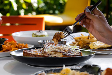 Lunch appetizer - toasts from brown bread with sauces and spices outside restaurant interior