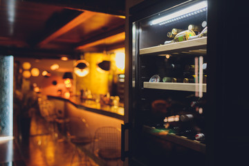 Storing bottles of wine in fridge. Alcoholic card in restaurant. Cooling and preserving wine.