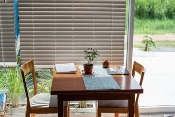 wood table and chair in living room near the window