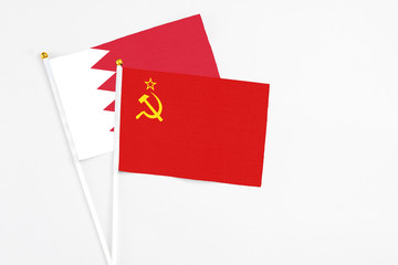 Soviet Union and Bahrain stick flags on white background. High quality fabric, miniature national flag. Peaceful global concept.White floor for copy space.