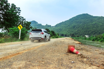 The old traffic cone falling on the road that was being repaired along the irrigation canal for...