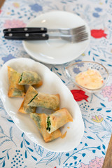 Spinach with cheese in deep fried spring rolls