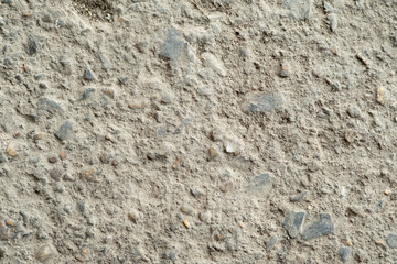 Dark grey asphalt pavement texture with small rocks.