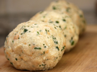 Big bread dumplings on a wood plate Semmelknödel