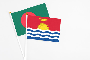 Kiribati and Bangladesh stick flags on white background. High quality fabric, miniature national flag. Peaceful global concept.White floor for copy space.