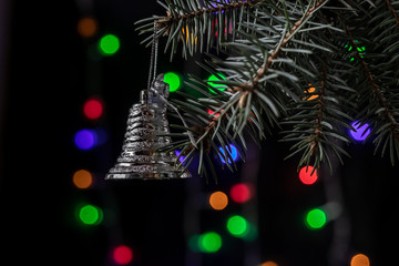 Christmas tree branch with toy. New Year 2020. On a dark background bokeh
