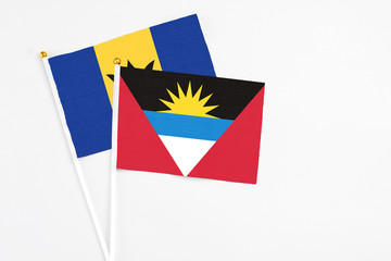 Antigua and Barbuda and Barbados stick flags on white background. High quality fabric, miniature national flag. Peaceful global concept.White floor for copy space.