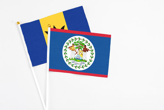 Belize and Barbados stick flags on white background. High quality fabric, miniature national flag. Peaceful global concept.White floor for copy space.