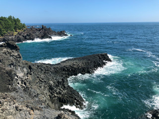 waves crashing on volcano rocks in Korea