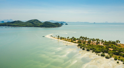 Aerial view above sand beach island with palms, Thailand.