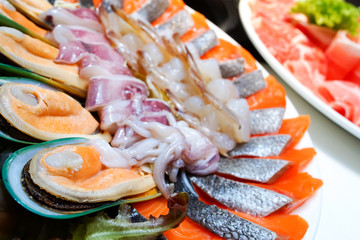 set of raw seafood preparing for sukiyaki hot pot