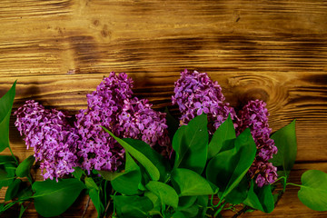 Purple lilac on wooden background. Top view, copy space