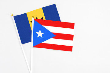 Puerto Rico and Barbados stick flags on white background. High quality fabric, miniature national flag. Peaceful global concept.White floor for copy space.