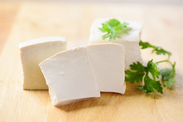 Sliced tofu on wooden background for cooking