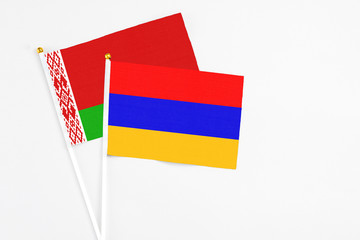 Armenia and Belarus stick flags on white background. High quality fabric, miniature national flag. Peaceful global concept.White floor for copy space.