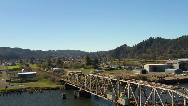 Aerial drone flying Reedsport Oregon railroad bridge