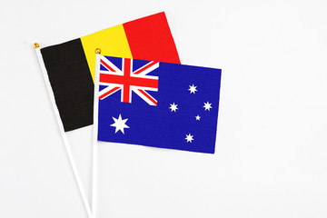 Fototapeta premium Australia and Belgium stick flags on white background. High quality fabric, miniature national flag. Peaceful global concept.White floor for copy space.