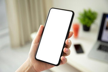 female hands holding phone with isolated screen in the room