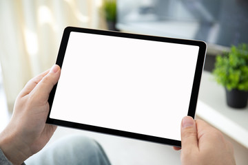 male hands holding computer tablet with isolated screen in room © DenPhoto