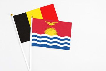 Kiribati and Belgium stick flags on white background. High quality fabric, miniature national flag. Peaceful global concept.White floor for copy space.