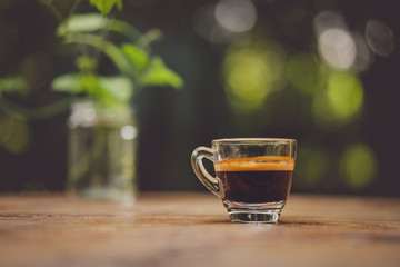 Espresso shot on wood table in cafe shop.