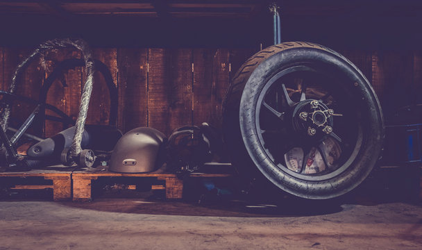 Motorcycle wheel on the floor with workshop tools, vintage garage, with blank copy space
