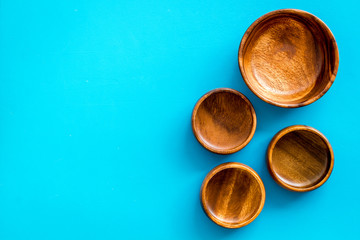 Making wooden dishes. Empty bowls on blue background top view copy space