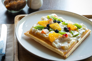 Waffle Fruity Kiwi Strawberry Blueberry Dessert. Fruity dessert food and drink category. Colorful Waffle Fruity. Close up shot. 45 degree angle.