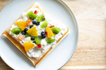 Waffle Fruity Kiwi Strawberry Blueberry Dessert. Fruity dessert food and drink category. Colorful Waffle Fruity. Close up shot. Top view.