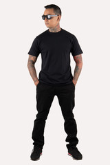 Tattooed man wearing black t-shirt and sunglasses isolated on white background.