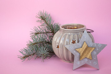 Christmas and New Year composition on a pink background. Flashlight and Christmas tree branches. Place for text.