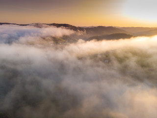 Aerial View landscape view white clouds in mountain and colorful sky at morning. Top clouds view from drone.