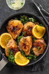 Pieces of chicken baked with oranges and red pepper.