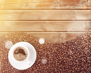 Coffee cup and coffee beans on  background