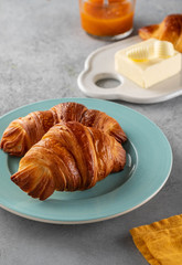 Delicious breakfast with fresh croissants and jam served with butter.