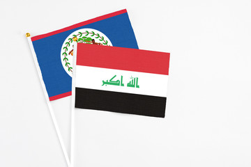 Iraq and Belize stick flags on white background. High quality fabric, miniature national flag. Peaceful global concept.White floor for copy space.