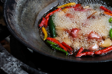 Boiled vegetable in iron pan, cooking and preparing important ingredient of making Thai chili paste