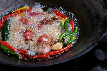 Boiled vegetable in iron pan, cooking and preparing important ingredient of making Thai chili paste