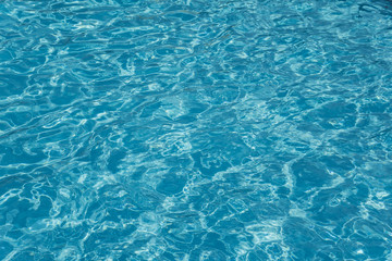 The texture of the crystal clear water in the pool. Safe swimming. Water in bright light