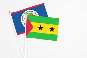 Sao Tome And Principe and Belize stick flags on white background. High quality fabric, miniature national flag. Peaceful global concept.White floor for copy space.