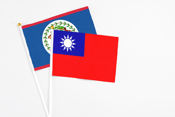 Taiwan and Belize stick flags on white background. High quality fabric, miniature national flag. Peaceful global concept.White floor for copy space.