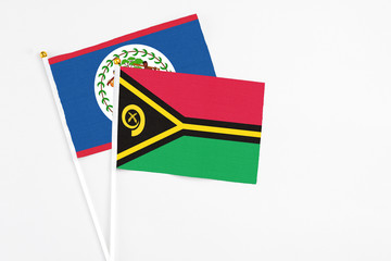 Vanuatu and Belize stick flags on white background. High quality fabric, miniature national flag. Peaceful global concept.White floor for copy space.