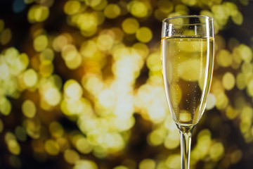 Glass with champagne against the background of a beautiful boke
