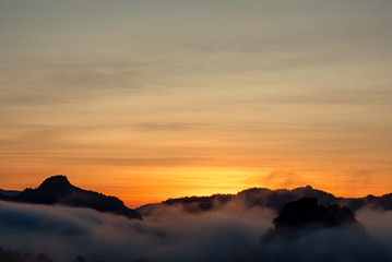 Sunrise and morning light behind the mountains with the mist covered.