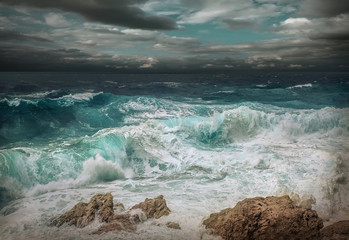Stormy sea view  near coastline at evening time. Waves, splashed