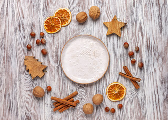 Сhristmas still life. White empty plate and christmas decor around. Wooden background. Flt lay, top view