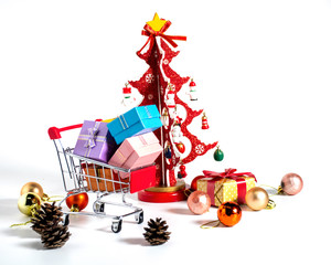 colorful christmas gift in trolley with christmas tree made with paper decorated with pine cone and colorful ball