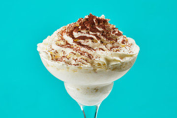 ice cream in glass with chocolate powder on Tiffani color background
