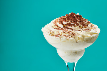 ice cream in glass with chocolate powder on Tiffani color background